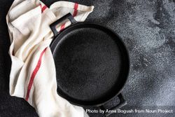 Empty cast iron pan as a table setting concept beXg2l