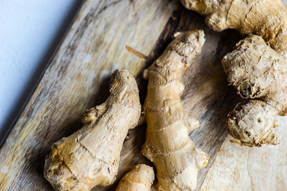 Raw ginger on wooden board