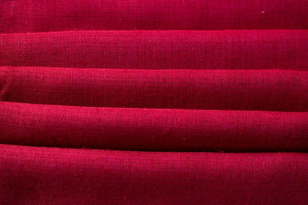 Close up Red fabric folded background texture.