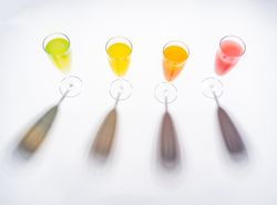 Glasses of bright colorful drinks on table