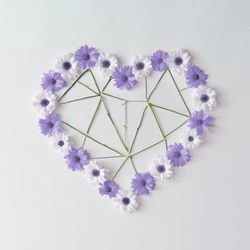 Heart shape made of violet and  daisies