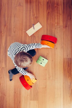 Boy playing with wooden construction pieces