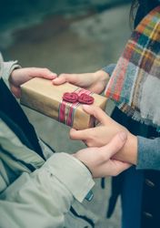 Hands exchanging a giftbox