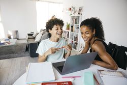 Girl doing her homework with mother