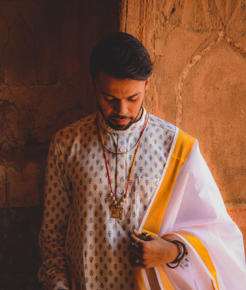 Portrait of man wearing traditional Indian clothing looking down