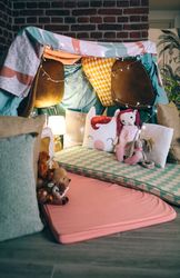 Makeshift kids tent made with chairs and sheets