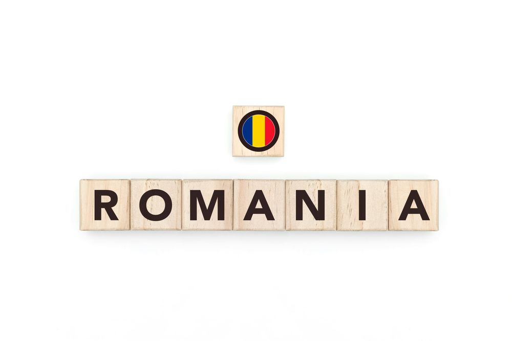 Wooden blocks bearing the name and flag of Romania. Romanian and East European Culture, national identity, travel, and geography in a copy space design.