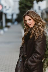 female standing on city street