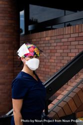 Portrait of Asian female nurse in PPE standing outside of medical building 4mWoz0