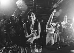 London, England, United Kingdom - Nov 9, 2022: happy woman at front of group on dance floor