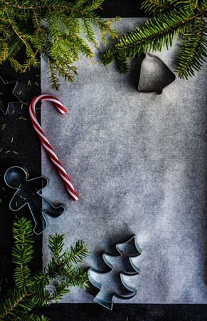 Christmas holiday concept of baking sheet with candy cane and cookie cutter