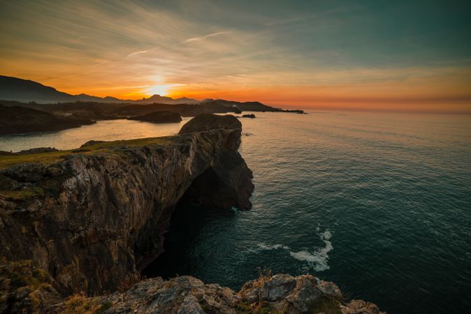 Majestic cliffs of ocean coastline in sunset