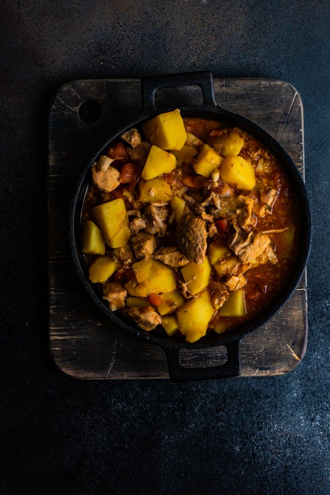 Top view of hearty Georgian meat and vegetable stew Souzi on wooden board