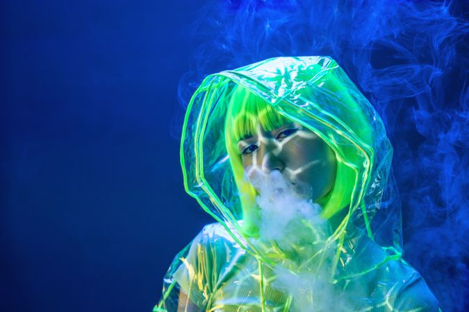 Asian woman smoking in fluorescent light