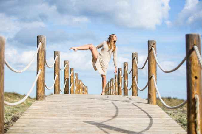 Young woman posing on footbridge