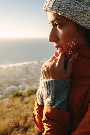 Close up side portrait of woman in winter wear looking at view outdoors