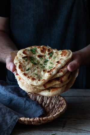 Crop man demonstrating naan bread
