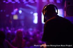 Man performing in silhouette against club lights 4mpVQ5