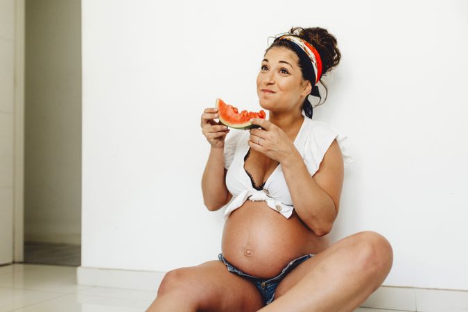 Pregnant female eating delicious watermelon