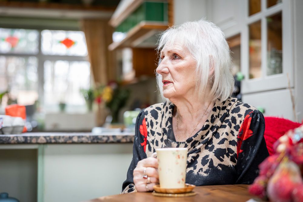 Woman with mug in kitchen