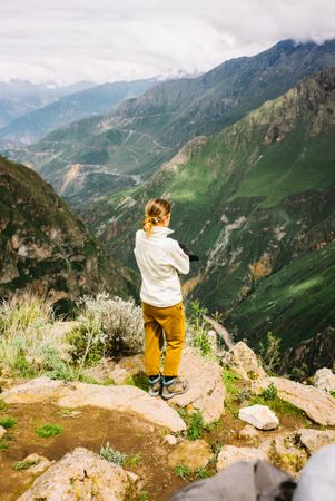 Female hiker taking in view in Peru mountains