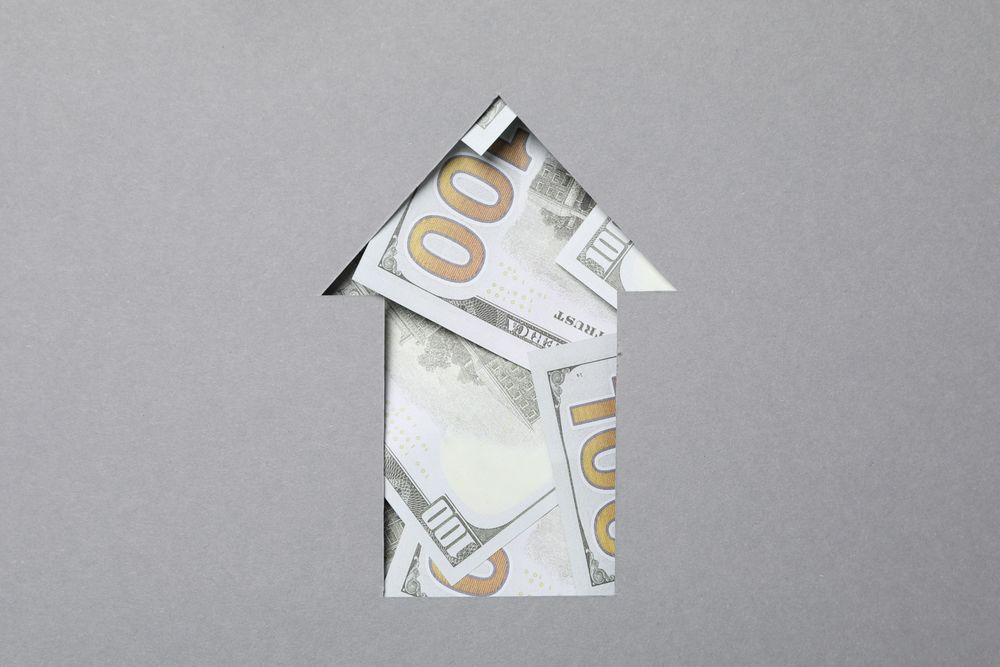 Up arrow with dollar bills, gray background