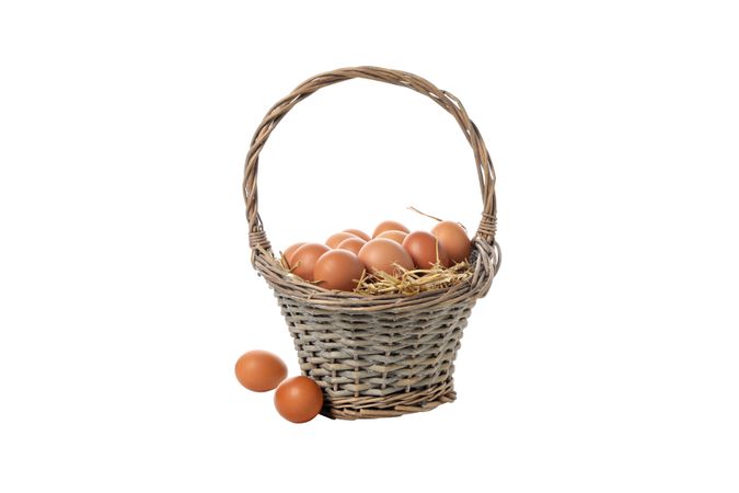 eggs in a wicker basket with handles, isolated on blank background.