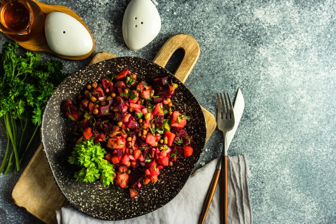 Top view of colorful beetroot salad on grey kitchen counter with copy space