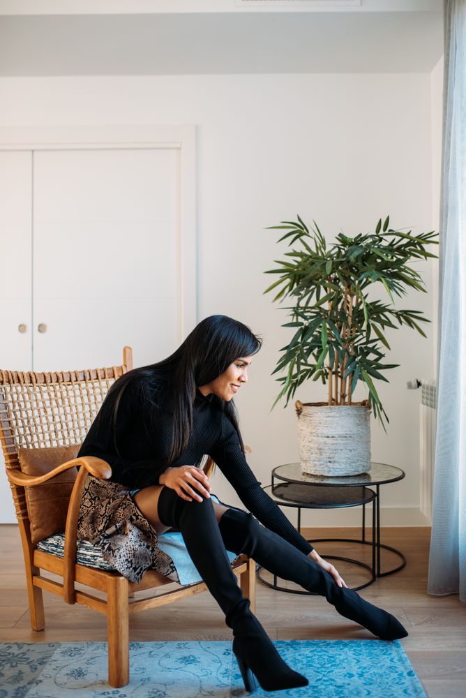 Stylist beautiful young Black woman sitting in a chair