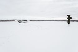 Car driving on icy field