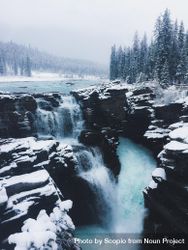 Waterfall on snow covered rocks 5lQna4