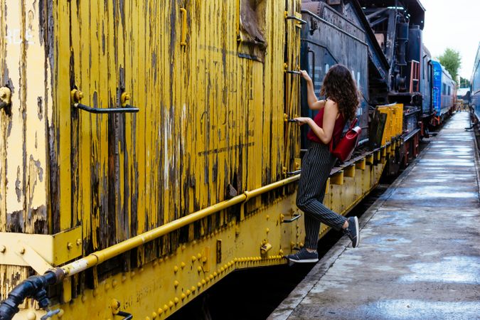 Woman holding on yellow train