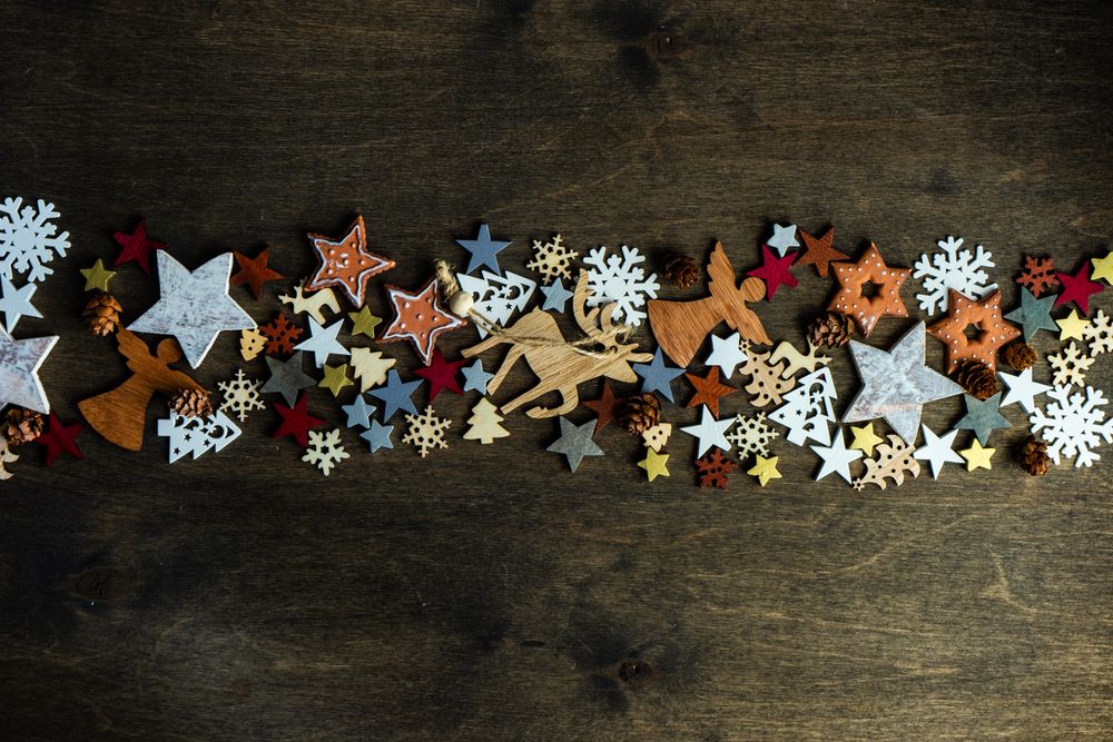 Top view of flat cut out Christmas ornaments in center of table