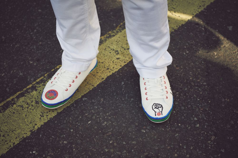 London, England, United Kingdom - March 19 2022: Front of sneakers with protest symbols drawn on