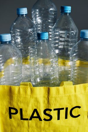 Plastic bottles in bag prepared for recycling