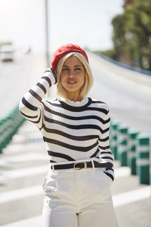 female in red beret outdoors
