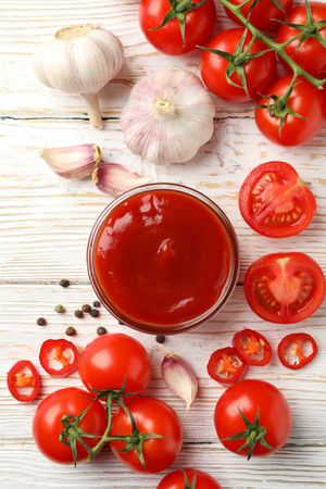 Composition with tomatoes on wooden background, top view