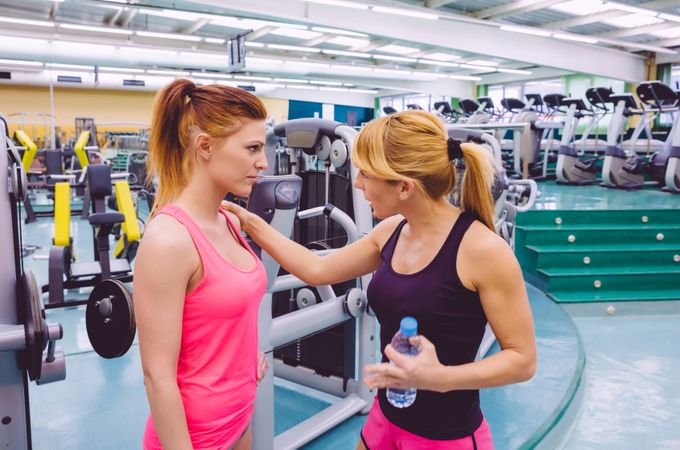 Two woman chatting in gym
