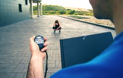 Coach timing woman as she breaks between work outs