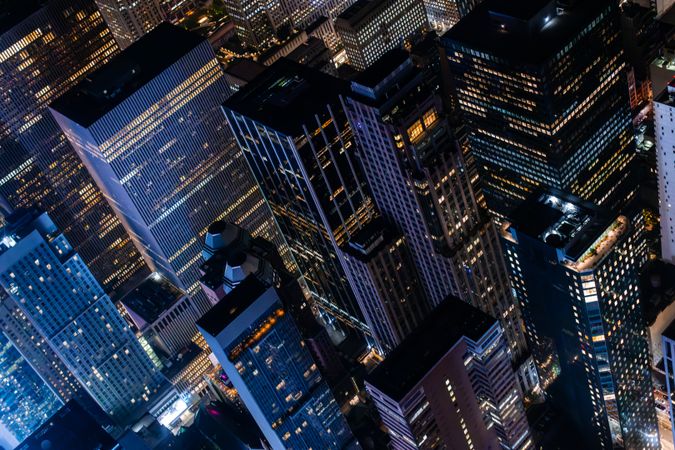 New York City Aerial Night Cityscape with Stunning Manhattan Landmarks, Skyscrapers and Residential Buildings. Helicopter Down View of the Urban Architecture