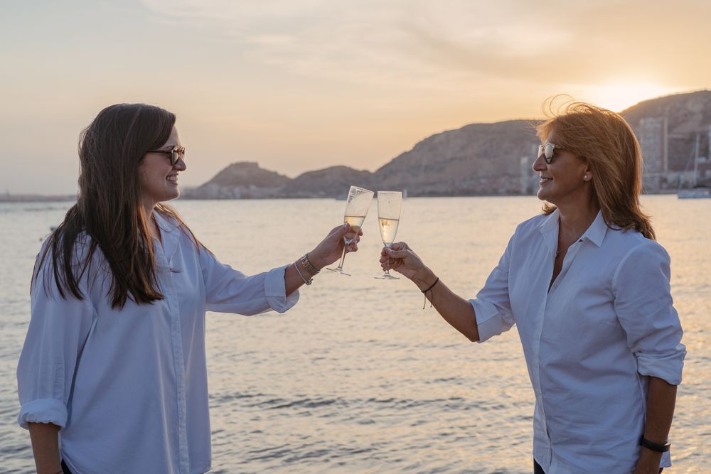 Happy family drinking wine on beach