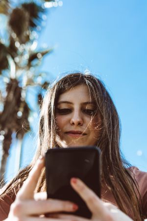 Teen girl looking at her smartphone.