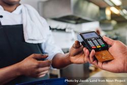 Hands of customer paying restaurant bill using credit card bYw815