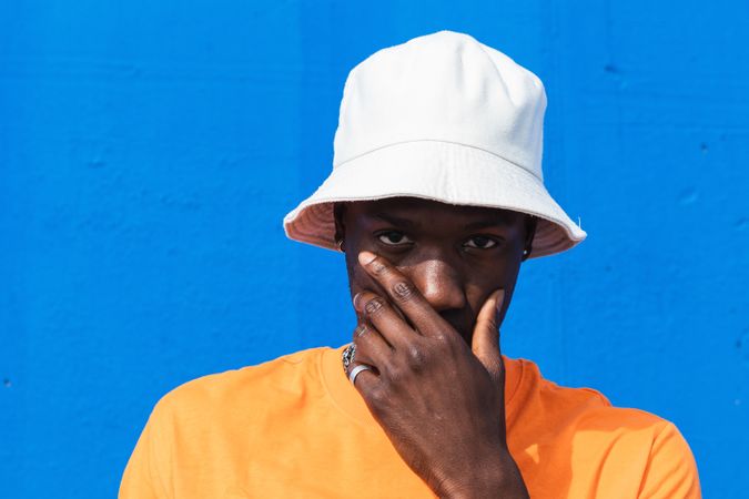 Black man in bright sporty outfit and cap