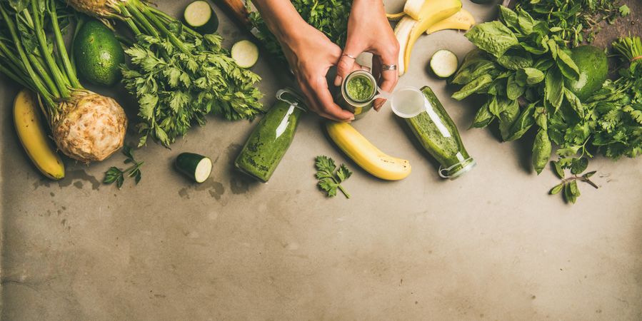 Smoothie ingredients, avocado, banana, zucchini,  on grey table, wide composition, copy space
