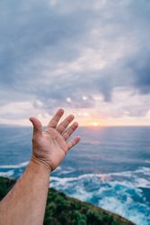 Person reaching for sea by hand