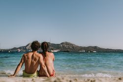 Happy couple hugging by sea