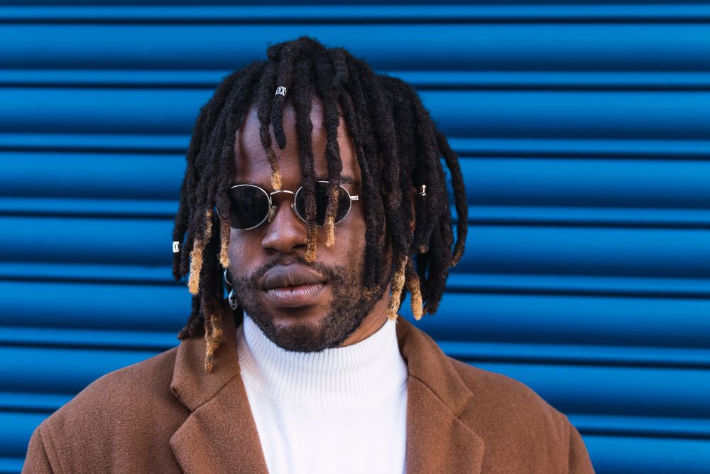 Black man in trendy sunglasses in city