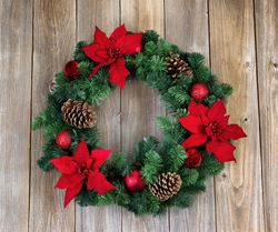 Holiday Poinsettia Christmas wreath on rustic wood