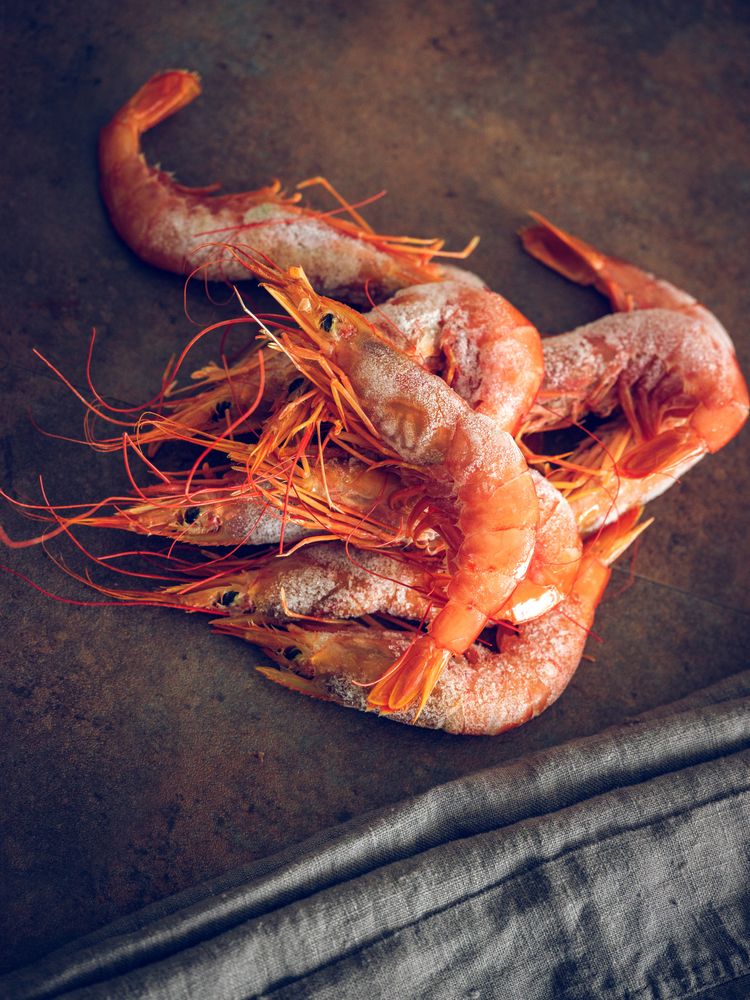Tasty raw shrimps on table